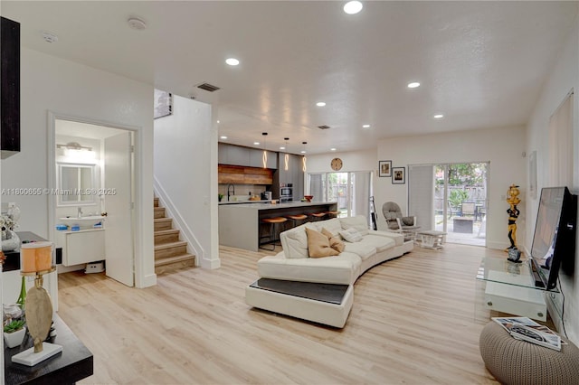 377 NE 34th Ter, Homestead, FL 33033 - living room featuring light wood-style floors, recessed lighting, stairway, and baseboards
