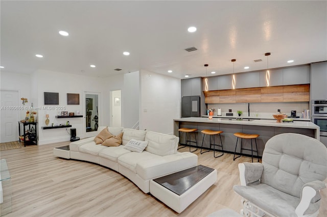 377 NE 34th Ter, Homestead, FL 33033 - living room with light wood-style floors and recessed lighting