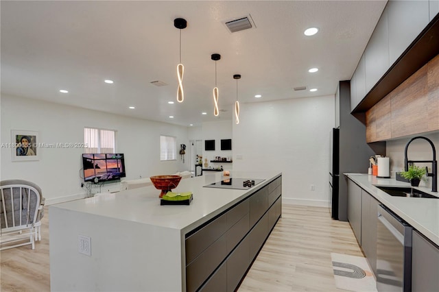 377 NE 34th Ter, Homestead, FL 33033 - kitchen featuring modern cabinets, black appliances, a sink, a large island, and light countertops