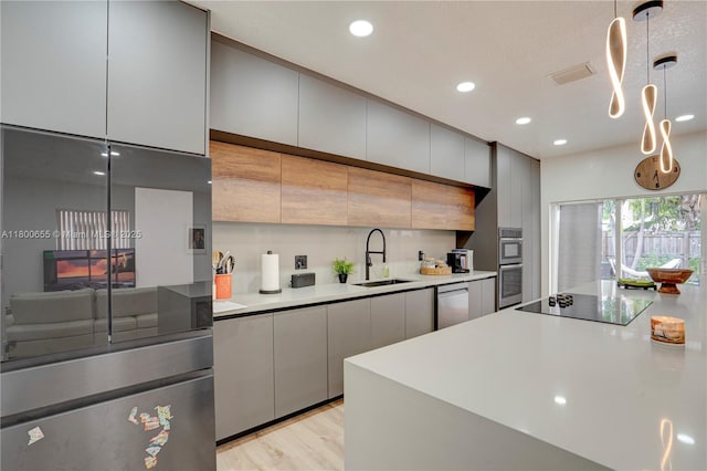377 NE 34th Ter, Homestead, FL 33033 - kitchen with a sink, stainless steel appliances, recessed lighting, light countertops, and gray cabinetry