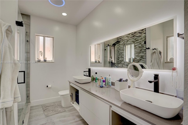 377 NE 34th Ter, Homestead, FL 33033 - bathroom with baseboards, a stall shower, double vanity, toilet, and recessed lighting