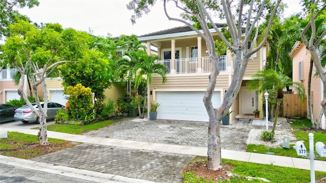 377 NE 34th Ter, Homestead, FL 33033 - beach home featuring an attached garage, decorative driveway, stucco siding, and fence