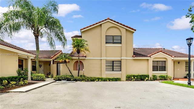 view of front of house with a tiled roof and stucco siding