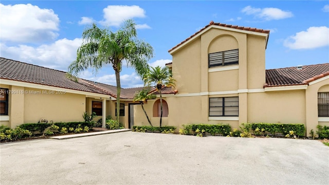 view of front of property with a tile roof and stucco siding