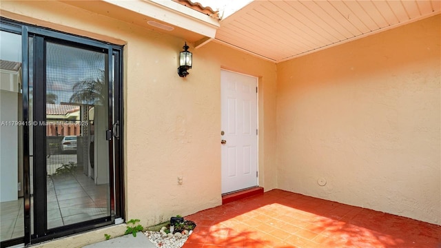 doorway to property with stucco siding