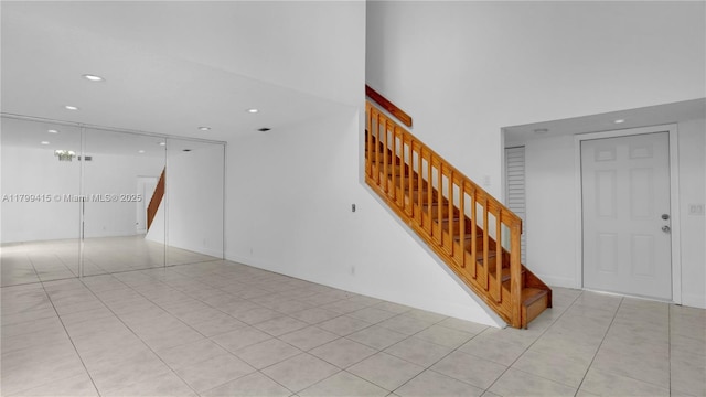 unfurnished living room featuring stairway, recessed lighting, and light tile patterned flooring
