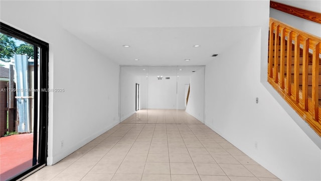 corridor featuring light tile patterned floors and recessed lighting