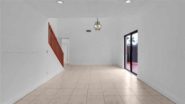 spare room with stairs, a chandelier, recessed lighting, light tile patterned floors, and baseboards
