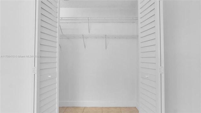 walk in closet featuring light tile patterned flooring