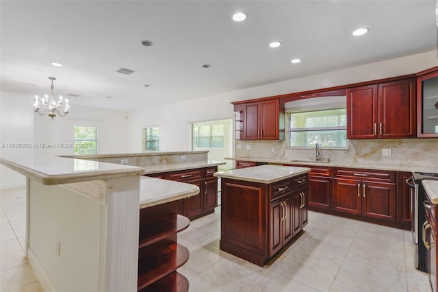 611 SW 8th St, Hallandale Beach, FL 33009 - kitchen with dark brown cabinets, a spacious island, decorative backsplash, a sink, and recessed lighting