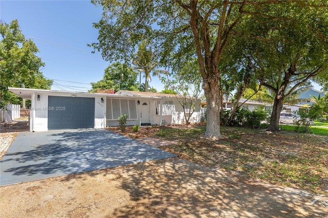ranch-style home featuring driveway and an attached garage