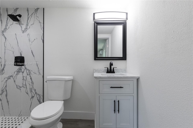 full bathroom featuring a marble finish shower, vanity, toilet, and wood finished floors