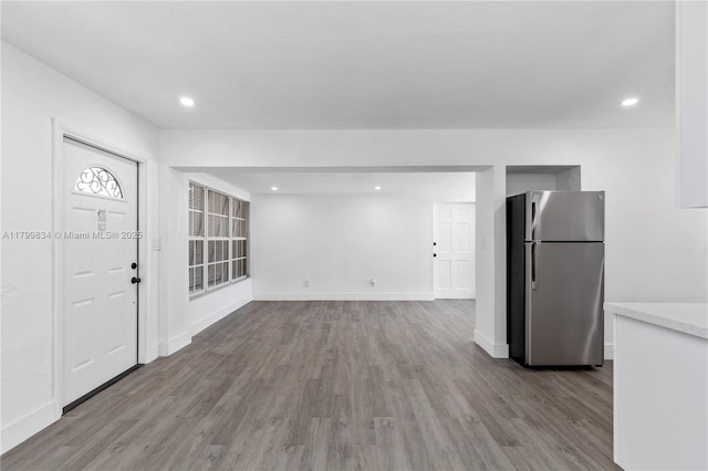 foyer with wood finished floors, recessed lighting, and baseboards