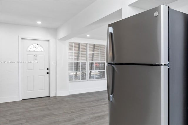 foyer entrance with recessed lighting, wood finished floors, and baseboards