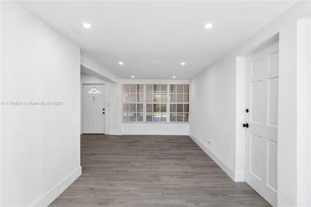 unfurnished room featuring baseboards, recessed lighting, and wood finished floors