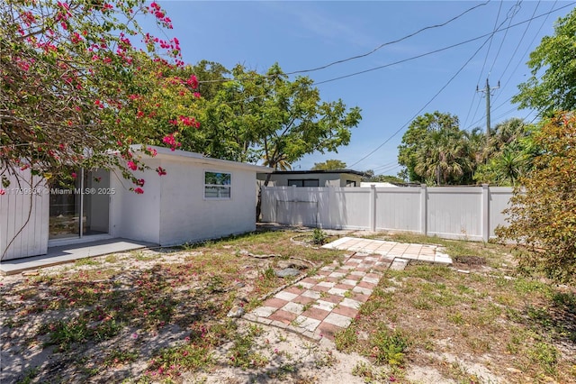 view of yard with fence and a patio