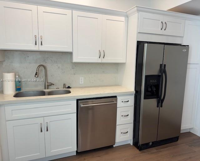 4200 Hillcrest Dr Unit 1017, Hollywood, FL 33021 - kitchen featuring appliances with stainless steel finishes, a sink, white cabinetry, light countertops, and backsplash