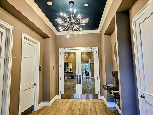 4200 Hillcrest Dr Unit 1017, Hollywood, FL 33021 - hall featuring french doors, a chandelier, wood finished floors, ornamental molding, and baseboards