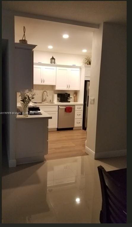 4200 Hillcrest Dr Unit 1017, Hollywood, FL 33021 - kitchen featuring stainless steel appliances, a sink, white cabinets, light countertops, and recessed lighting
