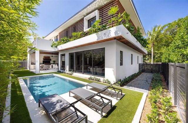 2905 Washington St, Miami, FL 33133 - back of property with stucco siding, a patio area, a balcony, a fenced backyard, and a ceiling fan