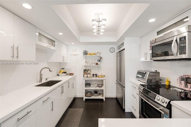 1700 NE 105th St Unit 108, Miami Shores, FL 33138 - kitchen with appliances with stainless steel finishes, a sink, white cabinetry, open shelves, and light countertops