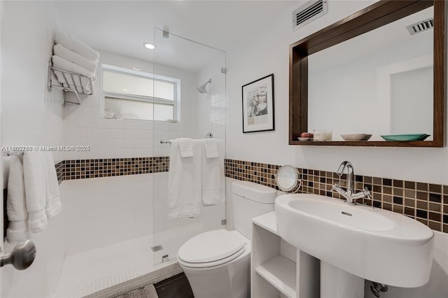 1700 NE 105th St Unit 108, Miami Shores, FL 33138 - bathroom featuring tiled shower, toilet, tile walls, and a sink
