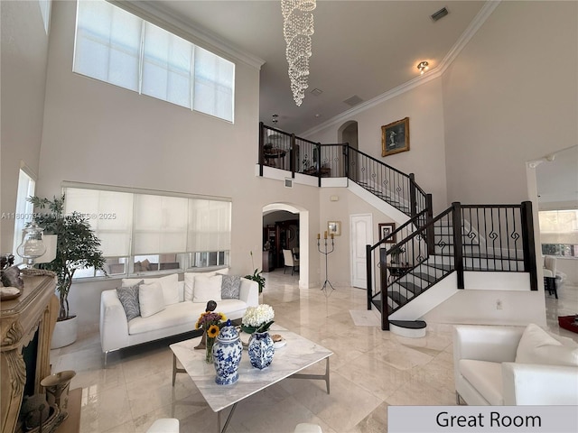8389 NW 115th Ct, Doral, FL 33178 - living area with arched walkways, a towering ceiling, ornamental molding, and stairs
