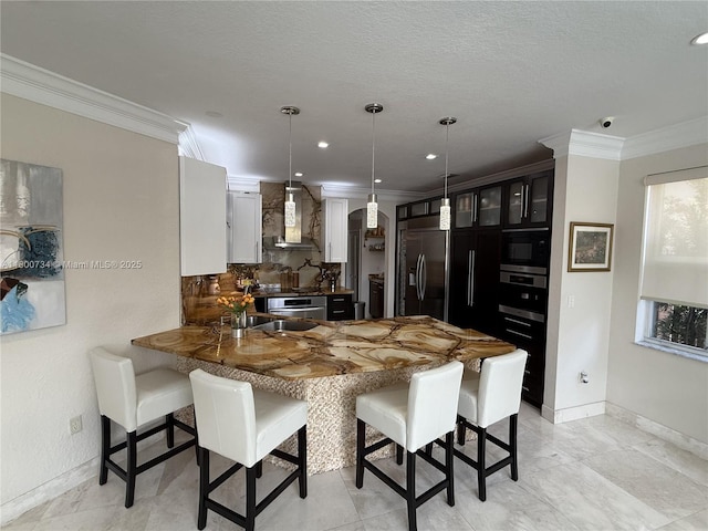 8389 NW 115th Ct, Doral, FL 33178 - kitchen featuring built in appliances, wall chimney range hood, a peninsula, baseboards, and ornamental molding