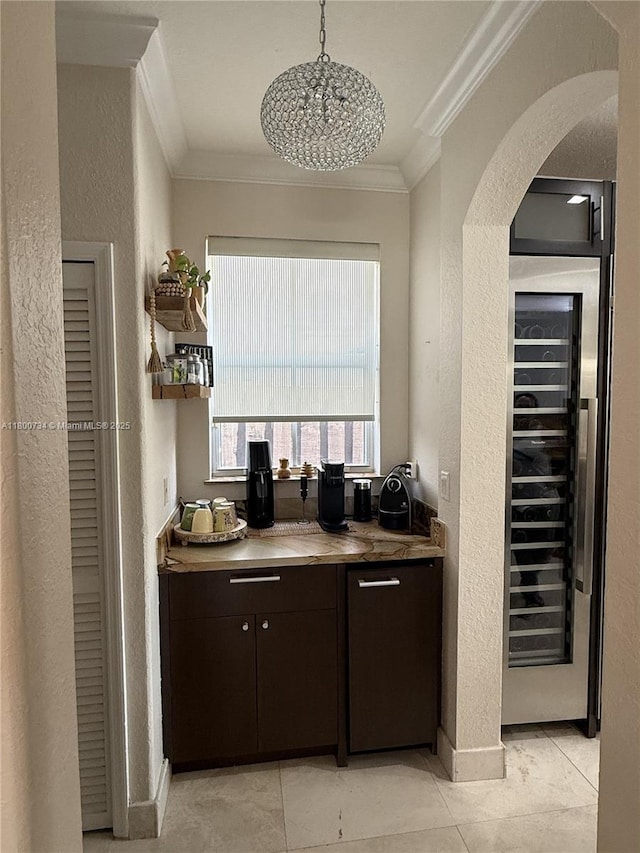 8389 NW 115th Ct, Doral, FL 33178 - bar area with a textured wall, ornamental molding, beverage cooler, arched walkways, and light tile patterned floors