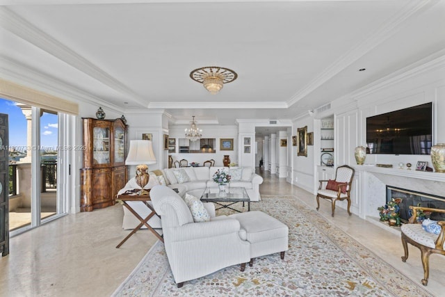 5266 Fisher Island Dr Unit 5266, Miami Beach, FL 33109 - living room featuring a chandelier, crown molding, built in features, and a fireplace