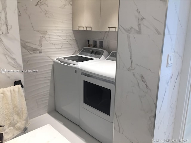 16485 Collins Ave Unit 538, Sunny Isles Beach, FL 33160 - clothes washing area with washing machine and clothes dryer and cabinet space