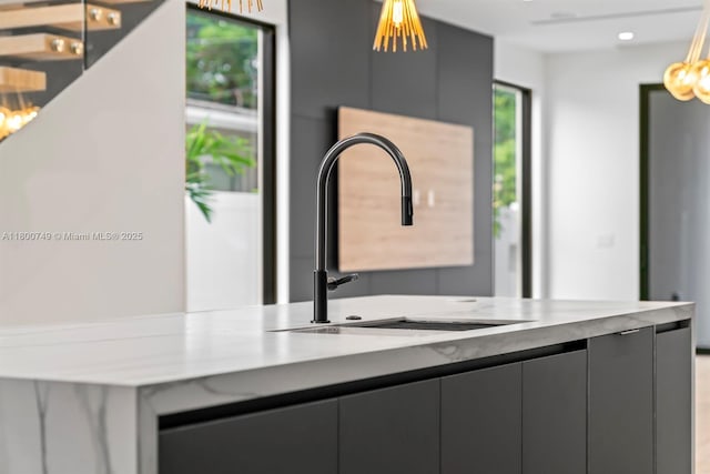 kitchen featuring a sink, modern cabinets, gray cabinetry, light countertops, and recessed lighting