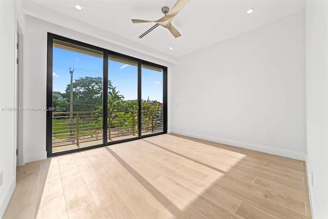 spare room with wood finished floors, ceiling fan, recessed lighting, and baseboards