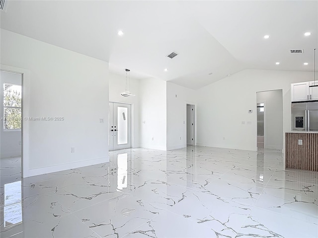 spare room with light marble finish floors, recessed lighting, and lofted ceiling