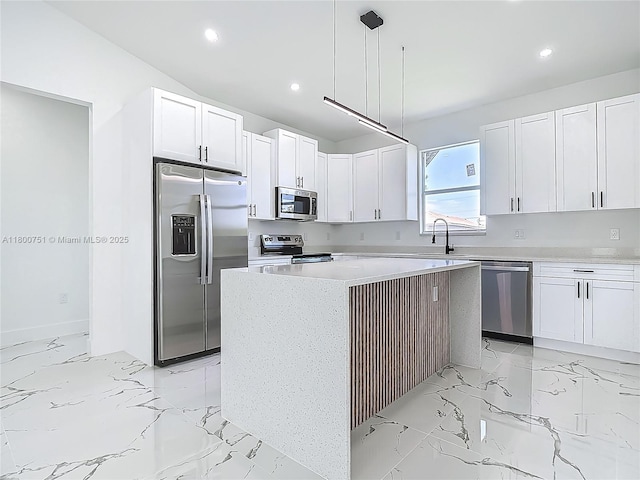 kitchen with appliances with stainless steel finishes, recessed lighting, a center island, and white cabinets