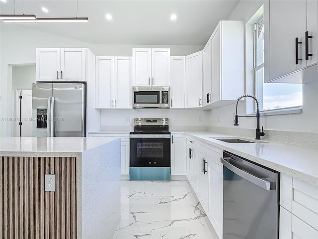 kitchen with appliances with stainless steel finishes, a sink, light marble finish floors, white cabinetry, and recessed lighting
