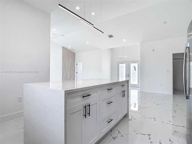 kitchen with light marble finish floors, french doors, white cabinetry, recessed lighting, and light stone counters