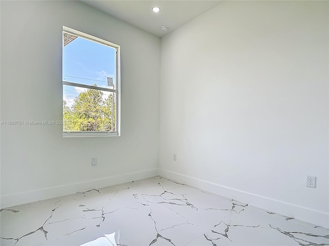 unfurnished room with baseboards and recessed lighting