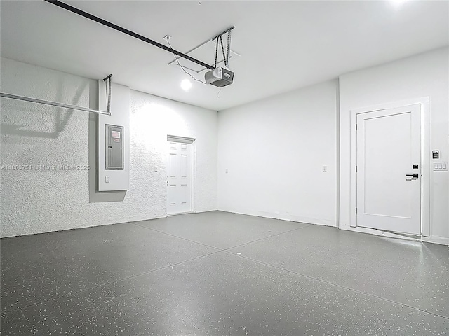 garage with a garage door opener and electric panel