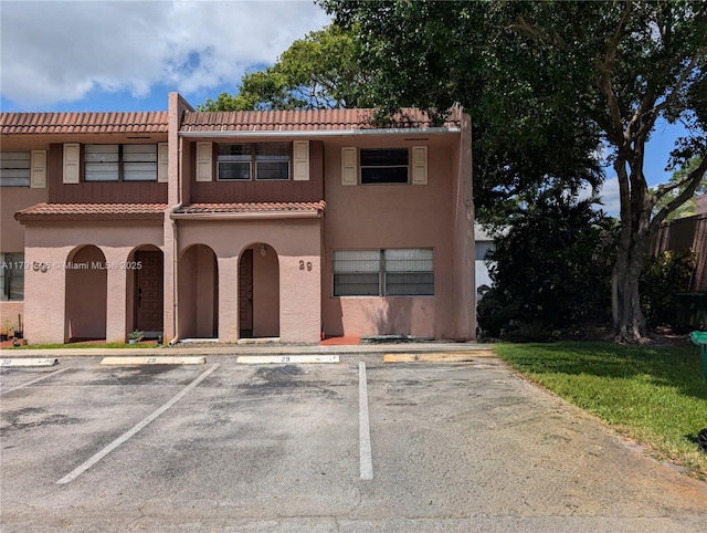 29 Seville Cir Unit 4-49, Davie, FL 33324 - view of front of house featuring a tiled roof, uncovered parking, and stucco siding
