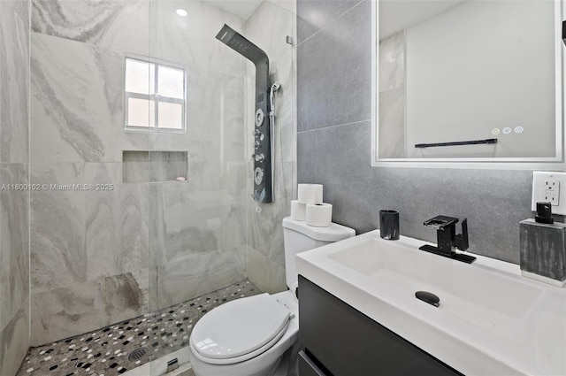 534 NW 50th St, Miami, FL 33127 - bathroom featuring toilet, tiled shower, tile walls, and vanity