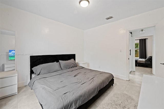534 NW 50th St, Miami, FL 33127 - bedroom featuring light tile patterned floors and baseboards