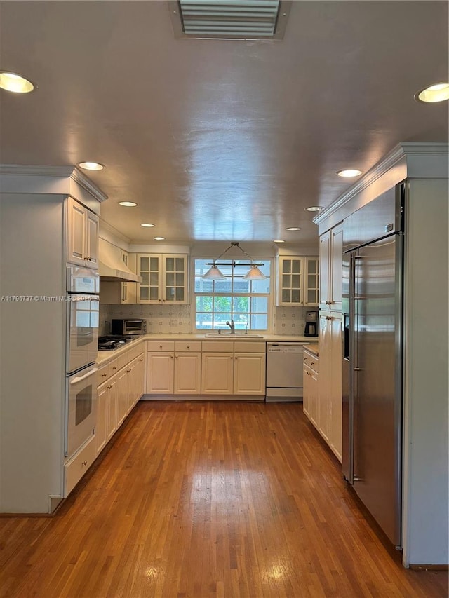 1234 NE 96th St, Miami Shores, FL 33138 - kitchen featuring appliances with stainless steel finishes, a sink, dark wood finished floors, light countertops, and recessed lighting