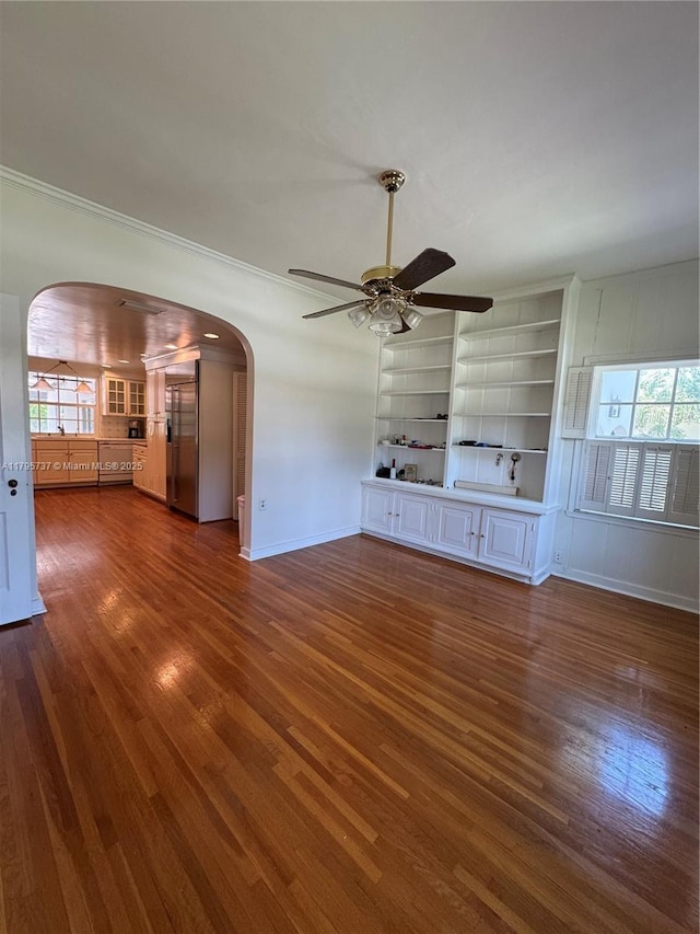 1234 NE 96th St, Miami Shores, FL 33138 - unfurnished living room featuring arched walkways, ceiling fan, dark wood-type flooring, baseboards, and crown molding