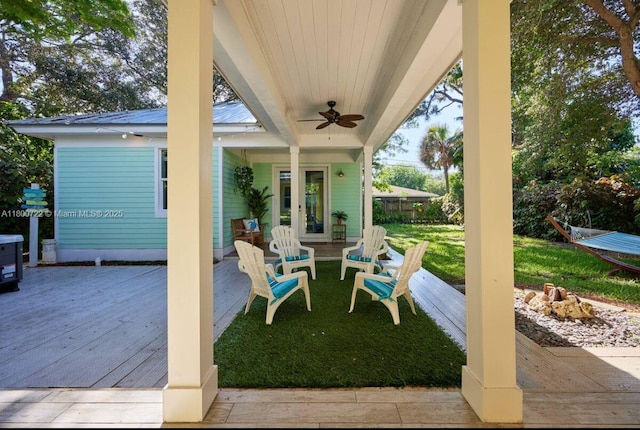 view of patio / terrace featuring a wooden deck, a ceiling fan, and french doors