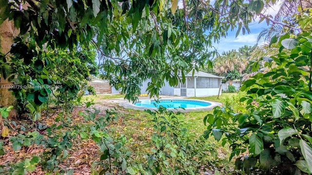 4878 Messana Ter, Lake Worth, FL 33463 - view of pool with a sunroom and a fenced backyard