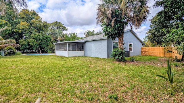 4878 Messana Ter, Lake Worth, FL 33463 - view of yard with a sunroom, a swimming pool, and central air condition unit