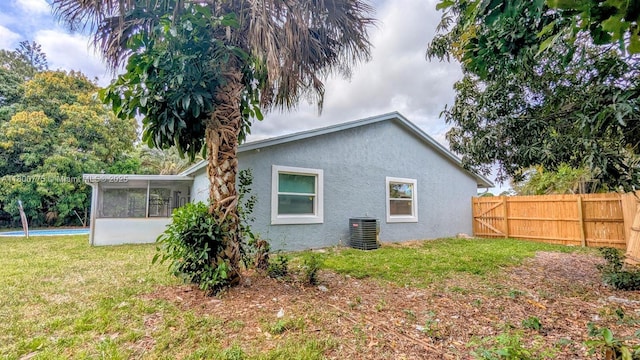 4878 Messana Ter, Lake Worth, FL 33463 - view of property exterior featuring a sunroom, central air condition unit, and stucco siding