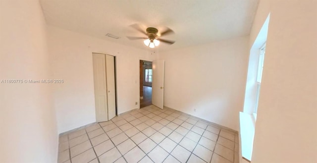 4878 Messana Ter, Lake Worth, FL 33463 - empty room with ceiling fan and light tile patterned floors