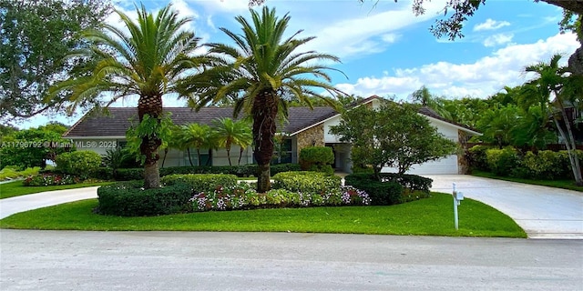 13021 NW 1st St, Plantation, FL 33325 - view of front of house featuring driveway, a front lawn, a tile roof, and stone siding